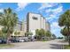 Oceanfront resort building with palm trees and parking at 200 76Th Ave. N # 411, Myrtle Beach, SC 29572