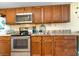 Kitchen with granite countertops and wood cabinets at 200 76Th Ave. N # 411, Myrtle Beach, SC 29572
