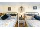 Bedroom with two twin beds and religious artwork at 200 76Th Ave. N # 411, Myrtle Beach, SC 29572