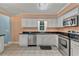 Modern kitchen with white cabinets, granite countertops, and stainless steel appliances at 504 13Th Ave. S, North Myrtle Beach, SC 29582