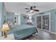 Main bedroom with king-size bed, access to the pool, and ceiling fan at 504 13Th Ave. S, North Myrtle Beach, SC 29582