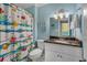Bathroom with granite countertop and beach-themed shower curtain at 504 13Th Ave. S, North Myrtle Beach, SC 29582
