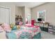 Bright bedroom with a bed featuring a patterned comforter, plus a desk and storage at 332 Kiskadee Loop # L, Conway, SC 29526