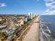 Aerial view of the coastline with beach, Ferris wheel and high-rises at 332 Kiskadee Loop # L, Conway, SC 29526
