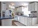 Modern kitchen with white cabinets, updated appliances, and laundry area at 527 Folly Estates Dr., Myrtle Beach, SC 29588