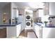 Modern kitchen with white cabinets, updated appliances, and laundry area at 527 Folly Estates Dr., Myrtle Beach, SC 29588