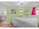 King-size bed, green walls, and view into living room at 6001 - 1749 S Kings Hwy., Myrtle Beach, SC 29575