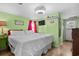 King-size bed, green walls, and beach-themed decor at 6001 - 1749 S Kings Hwy., Myrtle Beach, SC 29575