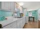 Kitchen with white cabinets, stainless steel appliances, and adjacent dining area at 6001 - 1749 S Kings Hwy., Myrtle Beach, SC 29575