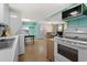 Kitchen with white appliances and open view into living room at 6001 - 1749 S Kings Hwy., Myrtle Beach, SC 29575