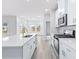 Modern kitchen with stainless steel appliances and white cabinets at 8605 Pinnacle Cove Way, Longs, SC 29568