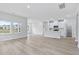 Open concept living area with kitchen island and hardwood floors at 8605 Pinnacle Cove Way, Longs, SC 29568