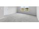 Bright bedroom with grey carpet and large window at 8605 Pinnacle Cove Way, Longs, SC 29568