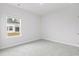 Spacious bedroom with grey carpet and a window offering backyard views at 8605 Pinnacle Cove Way, Longs, SC 29568