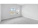 Bright bedroom with neutral walls and carpet, featuring two large windows at 8605 Pinnacle Cove Way, Longs, SC 29568
