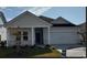 Charming one-story home with a covered porch and landscaped lawn at 8605 Pinnacle Cove Way, Longs, SC 29568