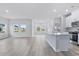 Bright and airy living room with hardwood floors and large windows at 8605 Pinnacle Cove Way, Longs, SC 29568