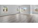 Spacious living area with hardwood floors and multiple windows at 8605 Pinnacle Cove Way, Longs, SC 29568