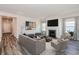 Gathering room with fireplace and staged furniture at 8605 Pinnacle Cove Way, Longs, SC 29568