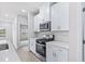 Modern kitchen with stainless steel appliances and white cabinetry at 8605 Pinnacle Cove Way, Longs, SC 29568