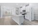 Open living area with kitchen island and hardwood floors at 8605 Pinnacle Cove Way, Longs, SC 29568