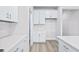 White kitchen features shaker cabinets and quartz countertops at 8605 Pinnacle Cove Way, Longs, SC 29568