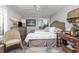 Bright bedroom with a queen-size bed, dresser, and sitting chair at 118 Salt Marsh Circle # 25-I, Pawleys Island, SC 29585