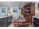 Cozy dining area with corner cabinet and round wooden table at 118 Salt Marsh Circle # 25-I, Pawleys Island, SC 29585