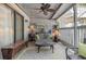 Cozy patio with seating area, ceiling fan, and wood storage bench at 118 Salt Marsh Circle # 25-I, Pawleys Island, SC 29585