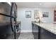 Modern kitchen with granite countertops and black appliances at 118 Salt Marsh Circle # 25-I, Pawleys Island, SC 29585