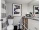 Clean bathroom with granite vanity, striped shower curtain, and wicker storage at 118 Salt Marsh Circle # 25-I, Pawleys Island, SC 29585
