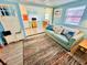 Living Room with teal couch and view into kitchen at 6001 - M26 S Kings Hwy., Myrtle Beach, SC 29575