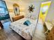 Bedroom with a full-size bed and seashell bedding, view of living room at 6001 - M26 S Kings Hwy., Myrtle Beach, SC 29575