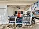 Inviting front porch with blue floor, seating, and string lights at 6001 - M26 S Kings Hwy., Myrtle Beach, SC 29575