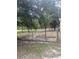 Fenced backyard with a garden plot and mature trees at 708 Grices Ferry Ct., Mullins, SC 29574