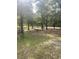 Spacious backyard with mature trees and seating area at 708 Grices Ferry Ct., Mullins, SC 29574