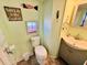 Charming bathroom with a toilet, sink, and beach decor at 6001 - 1781 S Kings Hwy., Myrtle Beach, SC 29575