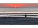 Person silhouetted at sunrise on the beach at 6001 - 1781 S Kings Hwy., Myrtle Beach, SC 29575
