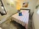 Bedroom with striped bedding and beach-themed art at 6001 - 1781 S Kings Hwy., Myrtle Beach, SC 29575
