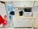 Kitchen with white cabinets, a coffee maker, and a view into living room at 6001 - 1781 S Kings Hwy., Myrtle Beach, SC 29575