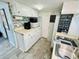 Kitchen boasts white cabinets, microwave, coffee maker, and a view into living area at 6001 - 1781 S Kings Hwy., Myrtle Beach, SC 29575