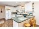 Modern kitchen boasting white cabinets, granite counters, and breakfast bar at 6001 - 1123 S Kings Hwy., Myrtle Beach, SC 29575