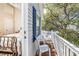 Small deck with white railing and two chairs, accessible from a bedroom at 6001 - 1123 S Kings Hwy., Myrtle Beach, SC 29575