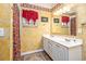 Double vanity bathroom with white cabinets, a shower, and decorative walls at 6001 - 1123 S Kings Hwy., Myrtle Beach, SC 29575