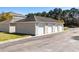 Three-car garage with light beige exterior at 336 Kiskadee Loop # B, Conway, SC 29526