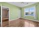 Light green bedroom with wood floors and window view at 336 Kiskadee Loop # B, Conway, SC 29526