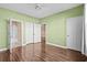 Bedroom with wood floors, light green walls, and bathroom access at 336 Kiskadee Loop # B, Conway, SC 29526