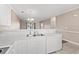 White kitchen with island and view to living area at 336 Kiskadee Loop # B, Conway, SC 29526