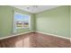 Light green bedroom with wood floors and a large window at 336 Kiskadee Loop # B, Conway, SC 29526