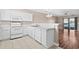 White kitchen with appliances, view to living room at 336 Kiskadee Loop # B, Conway, SC 29526